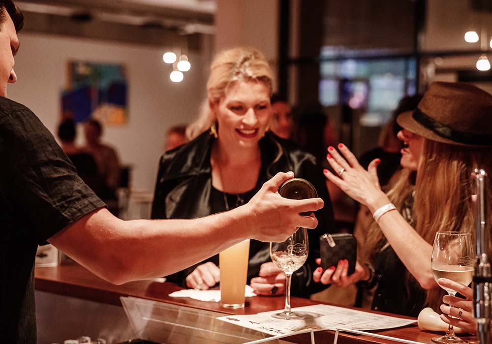 Bartender pouring wine for guests at the Montague Hotel bar